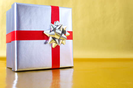 Gift box with golden backgroundの写真素材