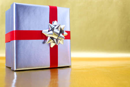 Gift box with golden backgroundの写真素材