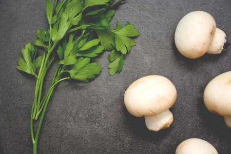 Mushrooms and parsley on slate tableの写真素材