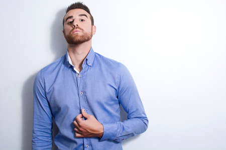 Young man posing as a model. Shadow in the wallの写真素材