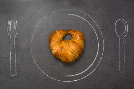 Croissant on slate tableの写真素材
