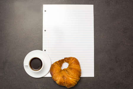 Coffee,croissant and sheet of paperの写真素材