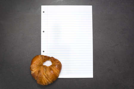 Croissant and sheet of paperの写真素材