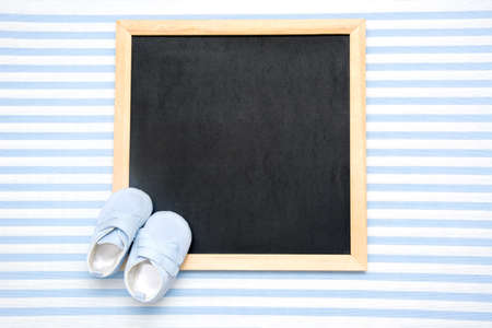 Baby shoes, letters, pacifier and paper envelopeの写真素材