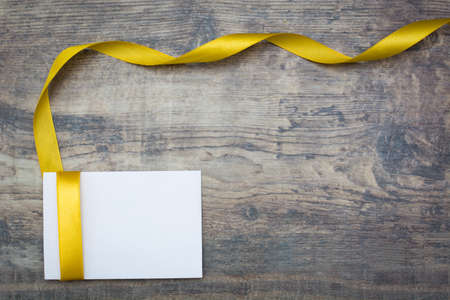 White card and golden ribbon