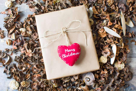 Rustic gift box surrounded by autumn leaves.の写真素材