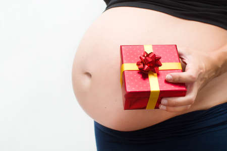 Pregnant woman with a gift box