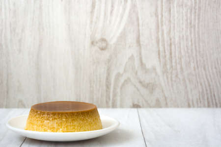 caramel custard on wood