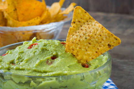 Nachos and guacamole on woodの写真素材