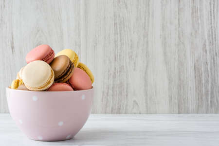 Colored macarons in a vintage bowlの写真素材