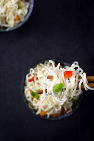 Asian noodles and vegetables on slateの写真素材