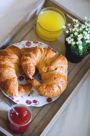 breakfast food on the bed inside a bedroom