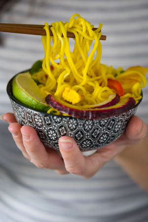 Woman eating thai noodlesの写真素材