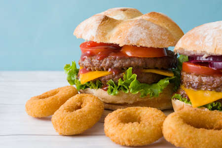 Homemade burgers and onion rings. Blue backgroundの写真素材