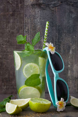 Summer drink. Fresh mojito on a rustic woodの写真素材