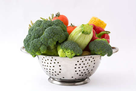 Vegetables in a colander. isolated photo