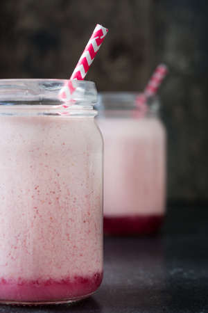 Delicious strawberry smoothie on a rustic wood