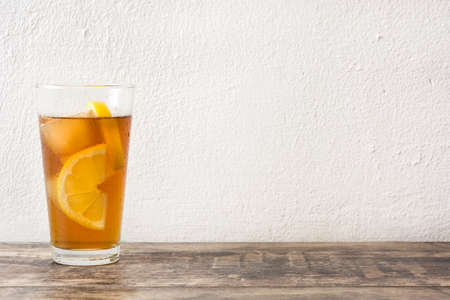 refreshing iced tea with lemon on woodの写真素材