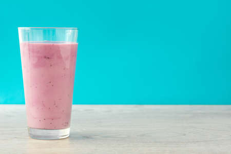 Fresh blueberry smoothie with blue backgroundの写真素材