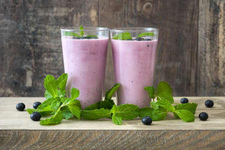 Fresh blueberry smoothie on woodの写真素材