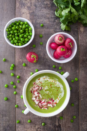 Peas cream with radishes on rustic wooden tableの写真素材