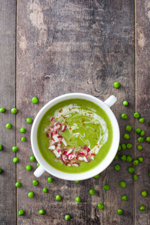 Peas cream with radishes on rustic wooden tableの写真素材