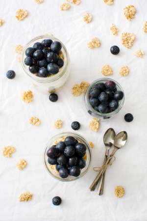 Yogurt with blueberries on white tableの写真素材