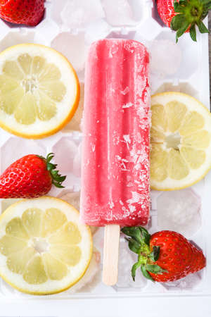 Strawberry ice pop on white backgroundの写真素材