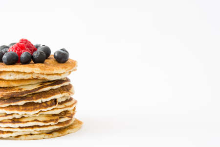 Pancakes with blueberries and raspberry isolated on white backgroundの写真素材