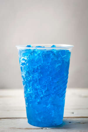 Blue summer slushie on white wooden tableの写真素材