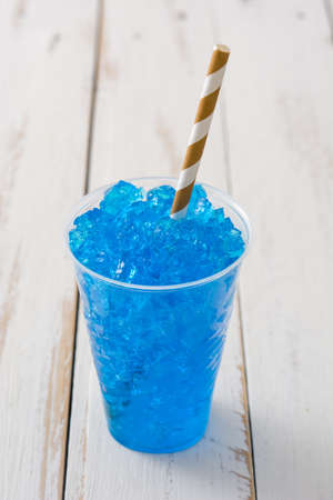 Blue summer slushie on white wooden tableの写真素材
