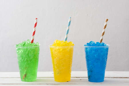 Colorful summer slushies on white woodの写真素材