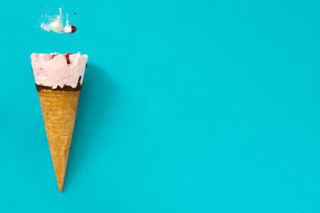 Strawberry ice cream cone on blue backgroundの写真素材