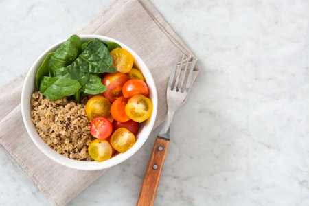 Quinoa with vegetables on marble tableの写真素材
