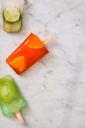 Fruit popsicles on marbleの写真素材