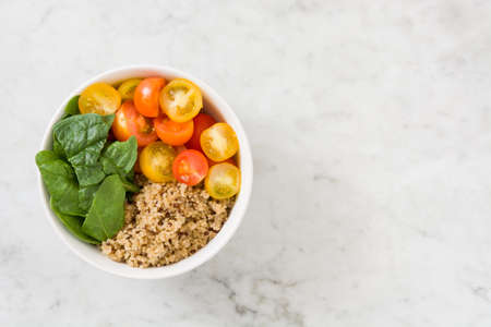 Quinoa with vegetables on marble table
