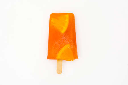 Homemade orange popsicle isolated on white backgroundの写真素材