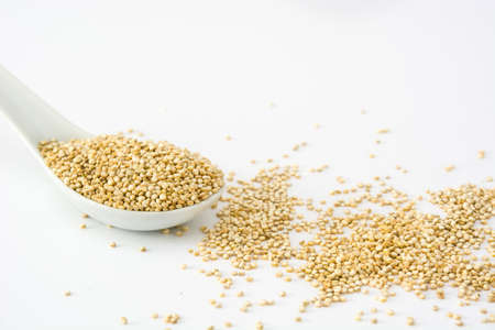 Quinoa in a spoon isolated on whiteの写真素材