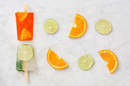 Orange and lime popsicle popsicle on marbleの写真素材