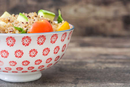 Quinoa salad on a rustic wooden tableの写真素材