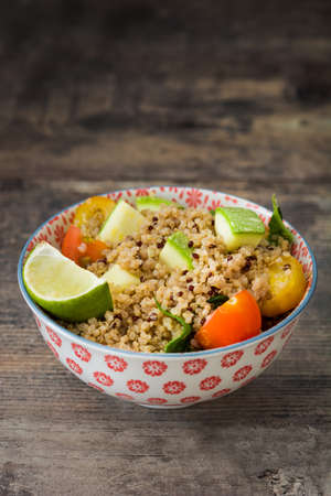 Quinoa salad on a rustic wooden tableの写真素材