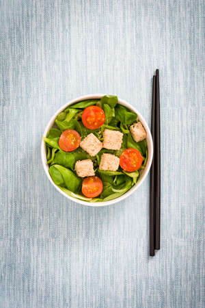 Vegan tofu salad with tomatoes and lamb's lettuceの写真素材