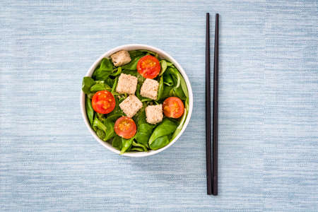 Vegan tofu salad with tomatoes and lamb's lettuceの写真素材