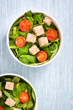 Vegan tofu salad with tomatoes and lamb's lettuceの写真素材