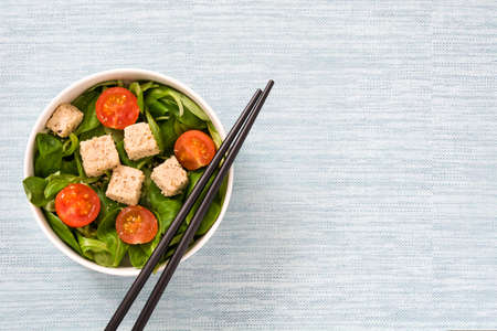 Vegan tofu salad with tomatoes and lamb's lettuceの写真素材