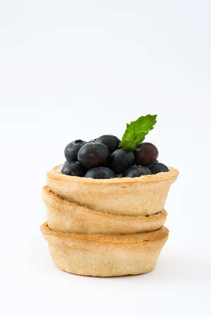 Delicious tartlet with raspberries and blueberries isolated on white backgroundの写真素材