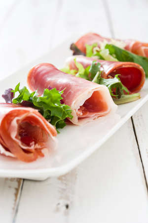 Spanish serrano ham on a white woodの写真素材