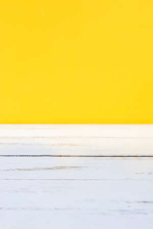 White wooden floor and yellow backgroundの写真素材