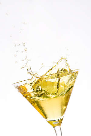 Yellow cocktail splash on white backgroundの写真素材
