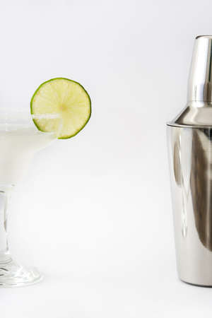 Margarita cocktail into a glass and shakers isolated on white backgroundの写真素材